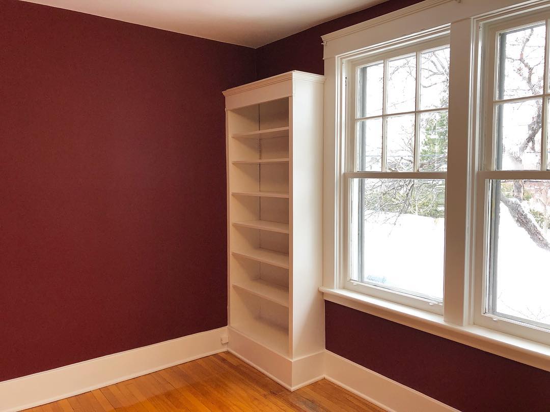 Detail-Oriented Interior Painting for Dubai Move-Outs Red wall painting with white trim, Dubai move-out